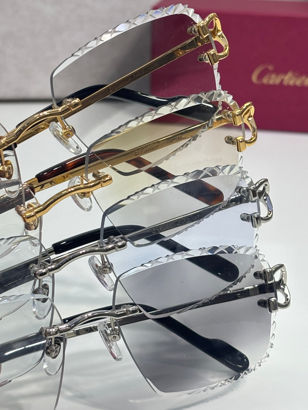 Eyeglasses with clear lenses and metal frames; gold and silver tones with hinges