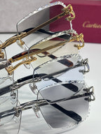 Eyeglasses with clear lenses and metal frames; gold and silver tones with hinges