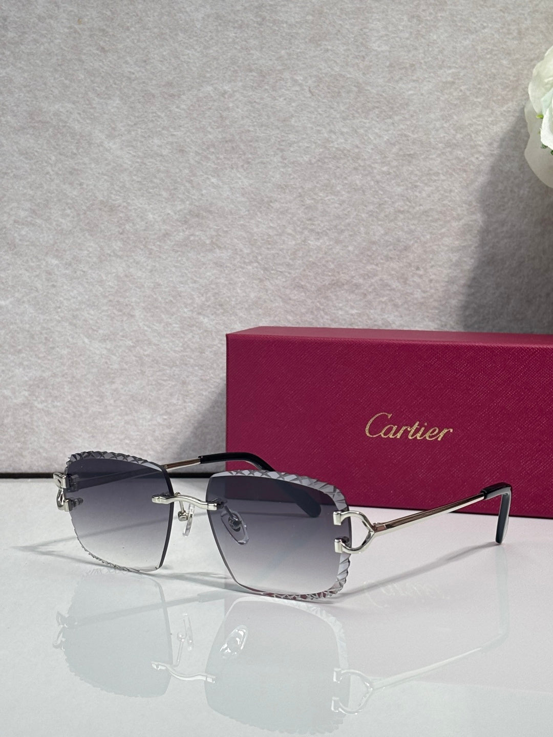 Cartier glasses with gold frame, dark lenses, and dark side arms with hinge details