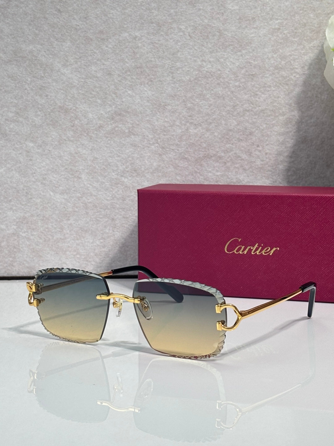 Cartier glasses with gold frame, amber lenses, and dark side arms with decorative trim