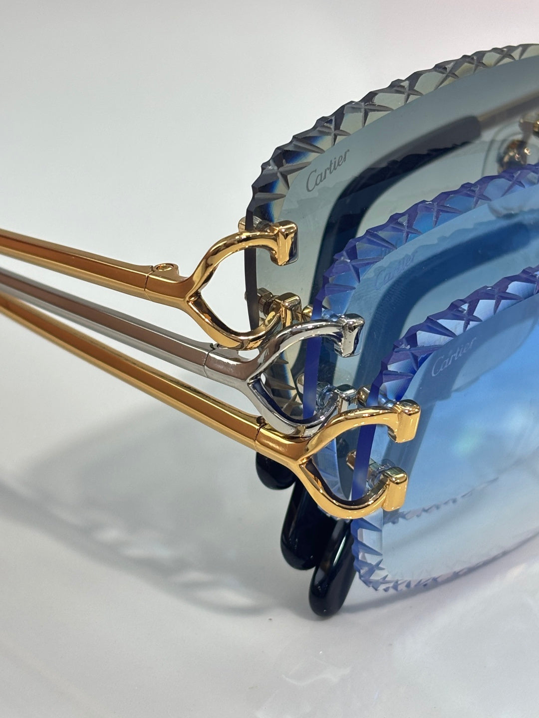 Cartier glasses side view with blue tinted lenses and gold metal temple frames