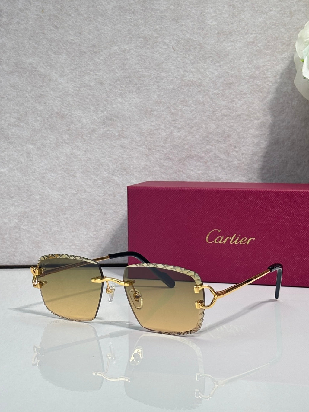 Cartier glasses with gold frame and light tan rounded lenses with dark side arms