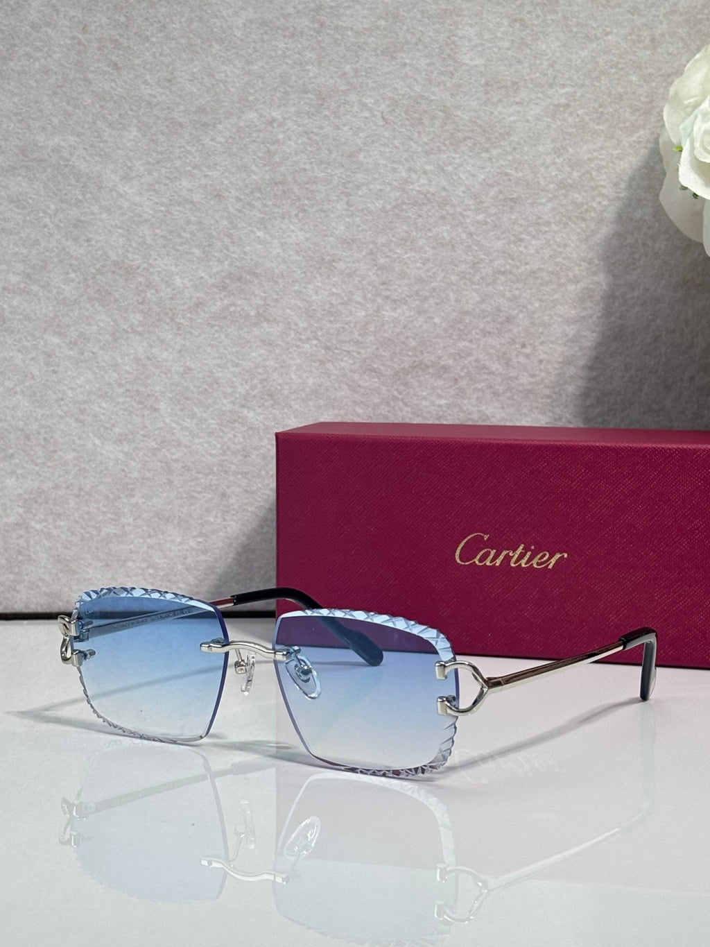 Cartier glasses with gold frame, light blue tinted lenses, and dark side arms
