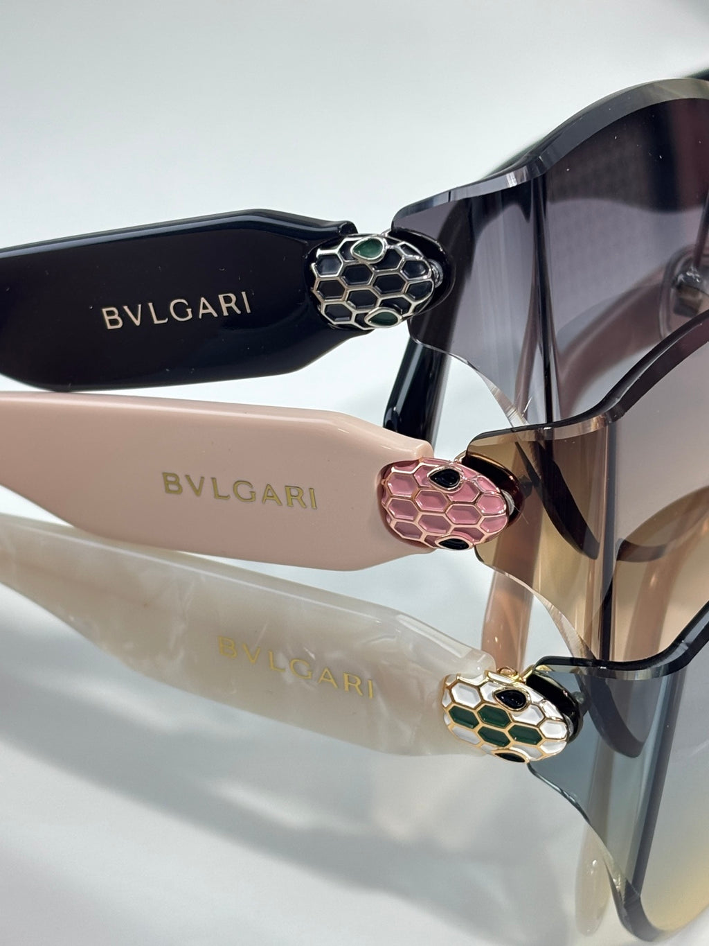 Bvlgari sunglasses close-up with dark frame and colorful floral hinge emblems