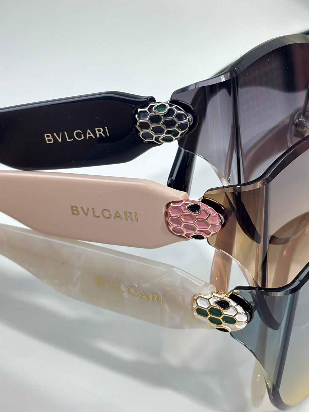 Bvlgari sunglasses close-up with dark frame and colorful floral hinge emblems