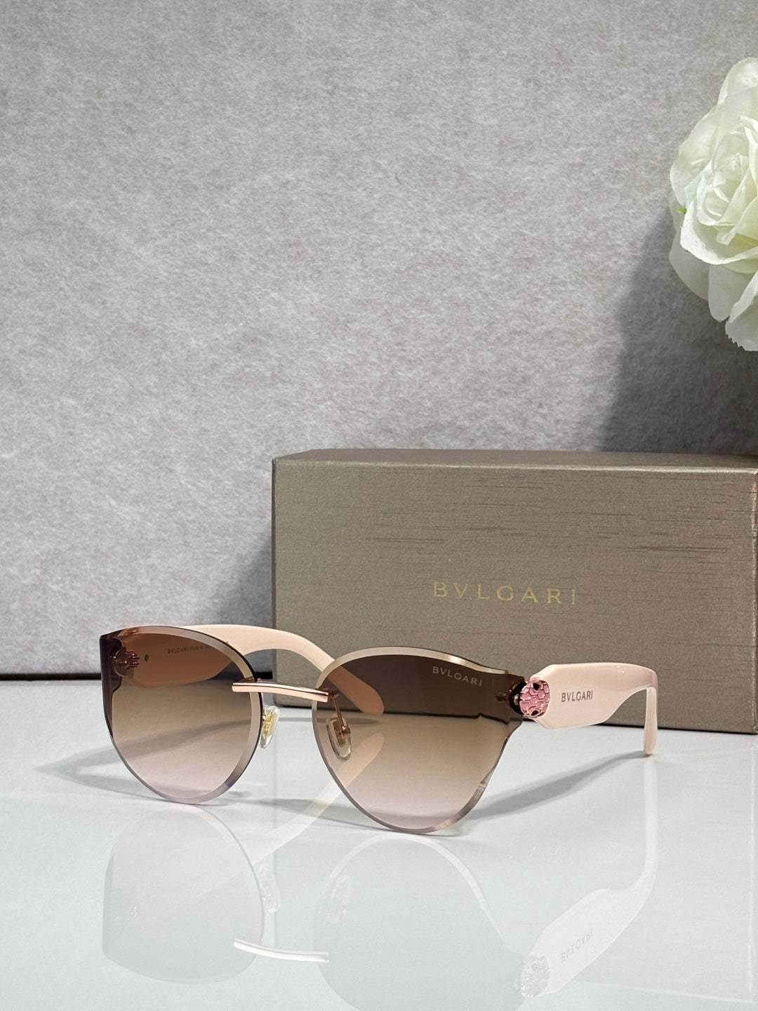 Bvlgari sunglasses with bronze-brown gradient lenses, gold-tone and white frame