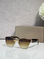Bvlgari sunglasses with gold-tone frame and dark brown gradient lenses, gold accents