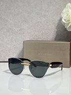 Bvlgari sunglasses with dark frame and dark lenses, gold accent at hinges