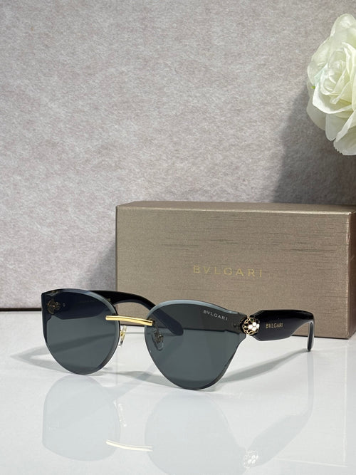 Bvlgari sunglasses with dark frame and dark lenses, gold accent at hinges