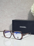 Eyeglasses with brown frame, blue lenses, CHANEL logo on temple