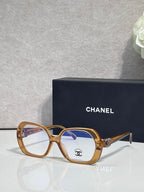 Eyeglasses with gold frame, blue lenses, CHANEL logo on temple