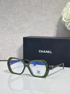 Eyeglasses with green frame, blue lenses, CHANEL logo on temple