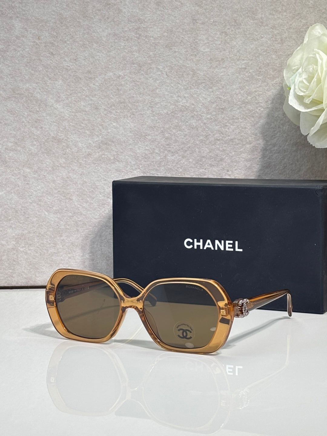 Chanel brown square sunglasses with gold-toned temple accents and tinted lenses.