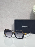 Chanel dark blue square sunglasses with logo on the temple and tinted lenses.