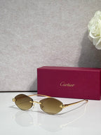 Cartier eyeglasses with gold-tone thin metal frame and amber lenses