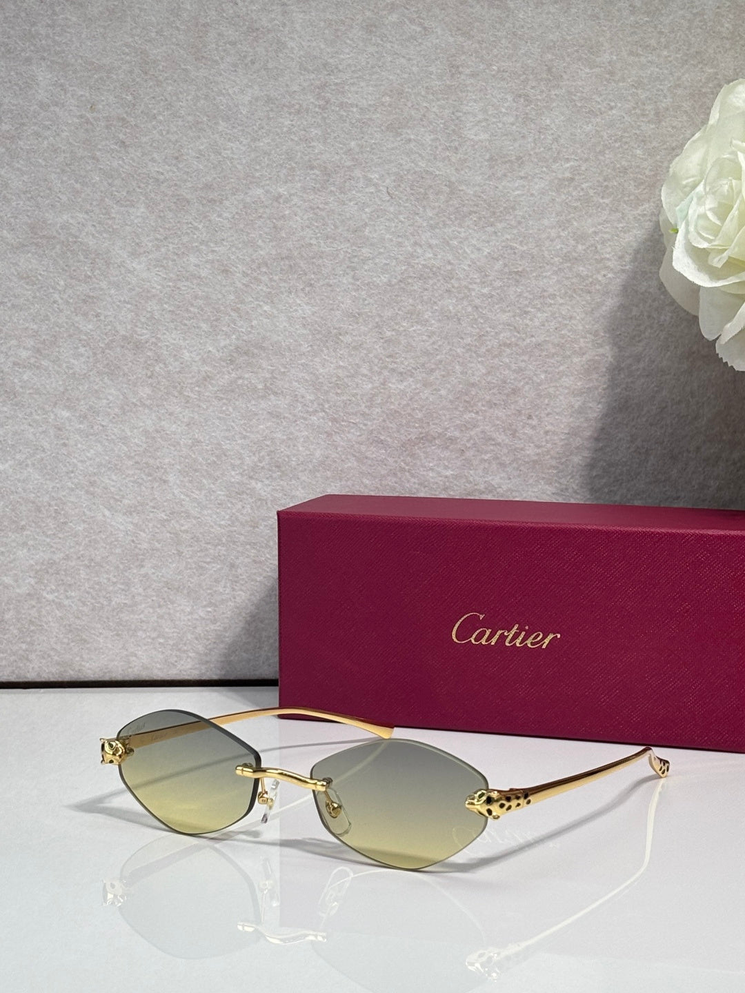 Cartier eyeglasses with gold-tone thin metal frame and light yellow lenses