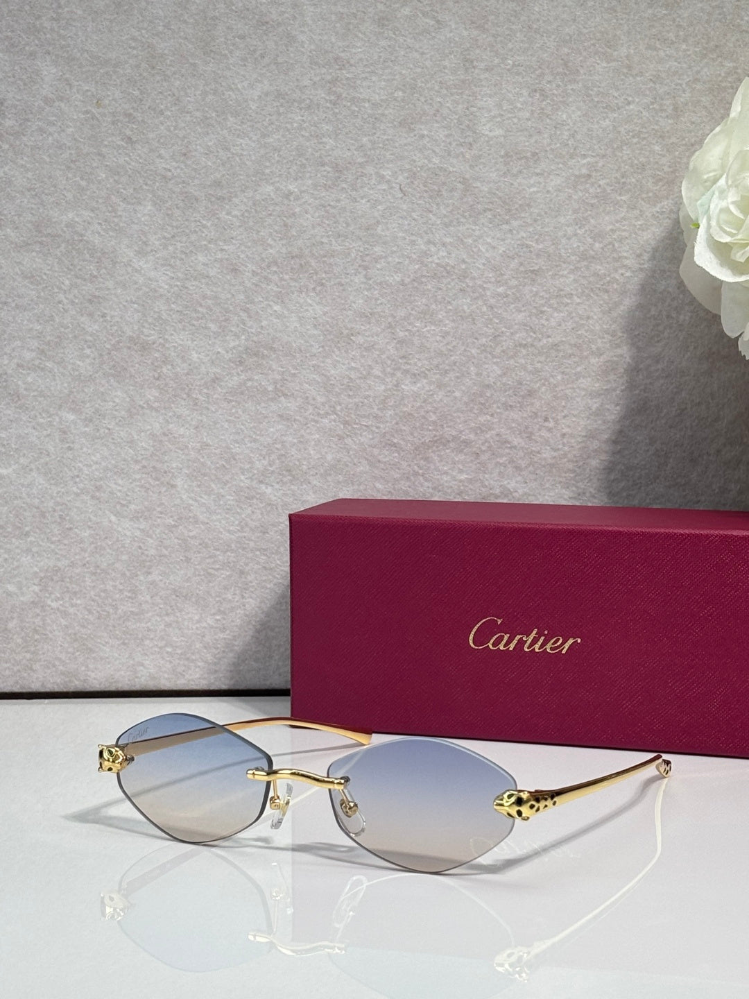 Cartier eyeglasses with gold-tone thin metal frame and light blue lenses