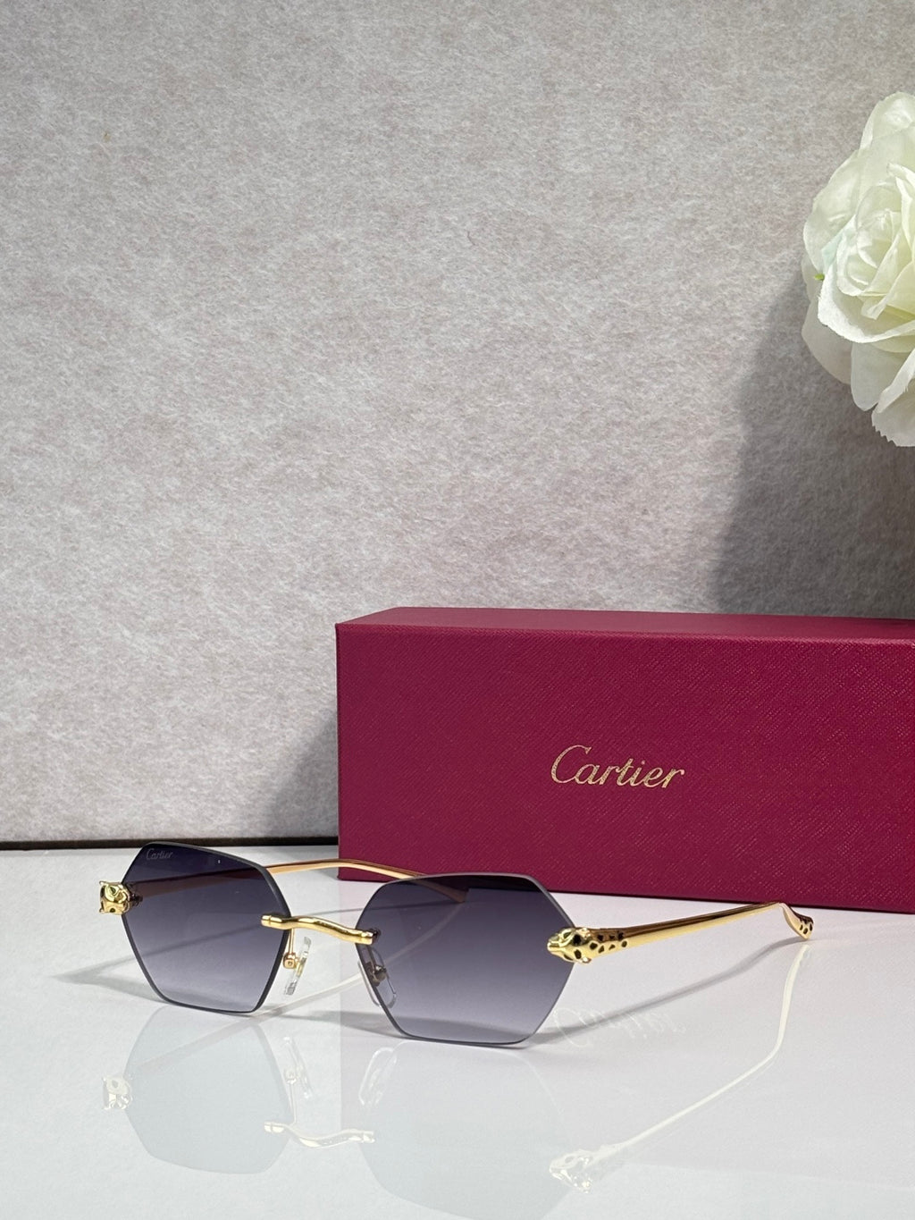 Cartier sunglasses with gold frame and dark gray-tinted lenses