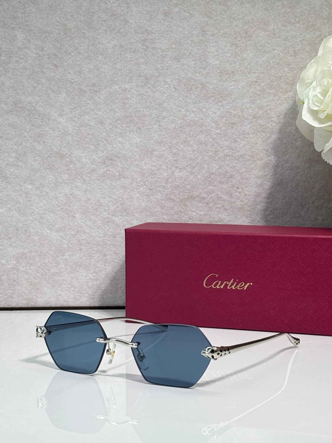 Cartier sunglasses with gold frame and blue-tinted lenses