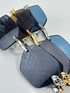 Cartier sunglasses close-up with blue-tinted lenses and gold accents