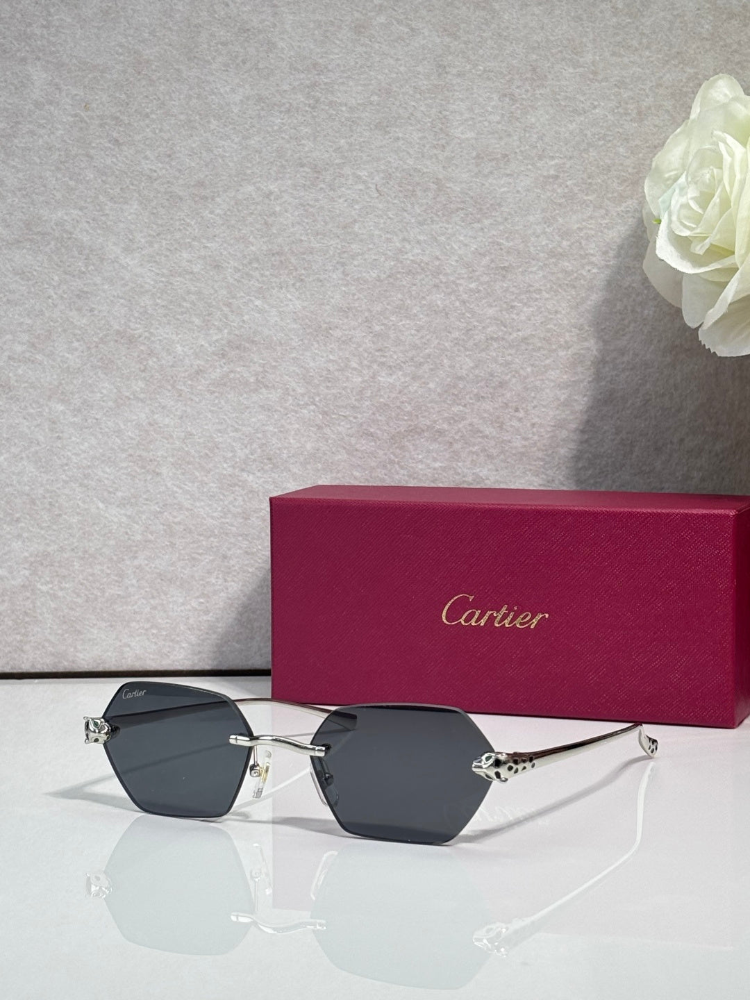 Cartier sunglasses with gold frame and dark gray-tinted lenses