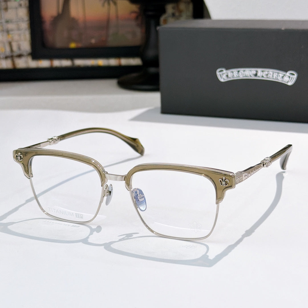Square eyeglasses with clear lenses, chrome frame, and gold patterned temple details