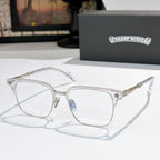 Square eyeglasses with clear lenses, chrome frame, and gold engraved temple details