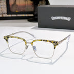 Square eyeglasses with clear lenses, chrome frame, and yellow-green patterned temples