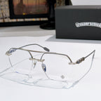 Silver metal eyeglass frames with clear lenses and ornate engraved temple