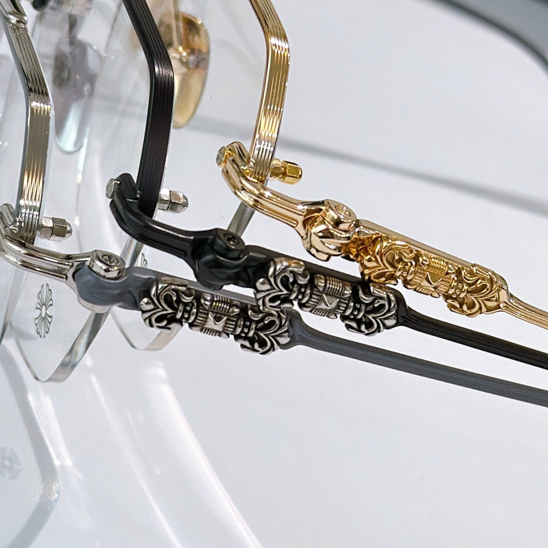 Close-up of gold and black eyeglass frame temples with engraved hinges
