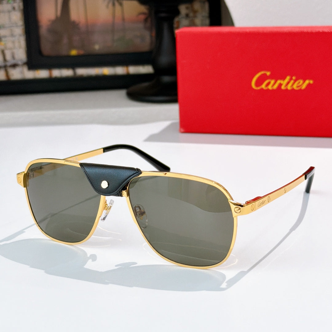 Sunglasses with gold frames and dark green-gray tinted lenses with black leather bridge detail