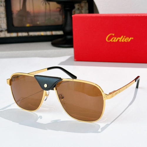 Sunglasses with gold frames, brown tinted lenses, and a dark leather bridge detail