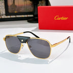 Sunglasses with gold frames, dark tinted lenses, and black leather bridge detail