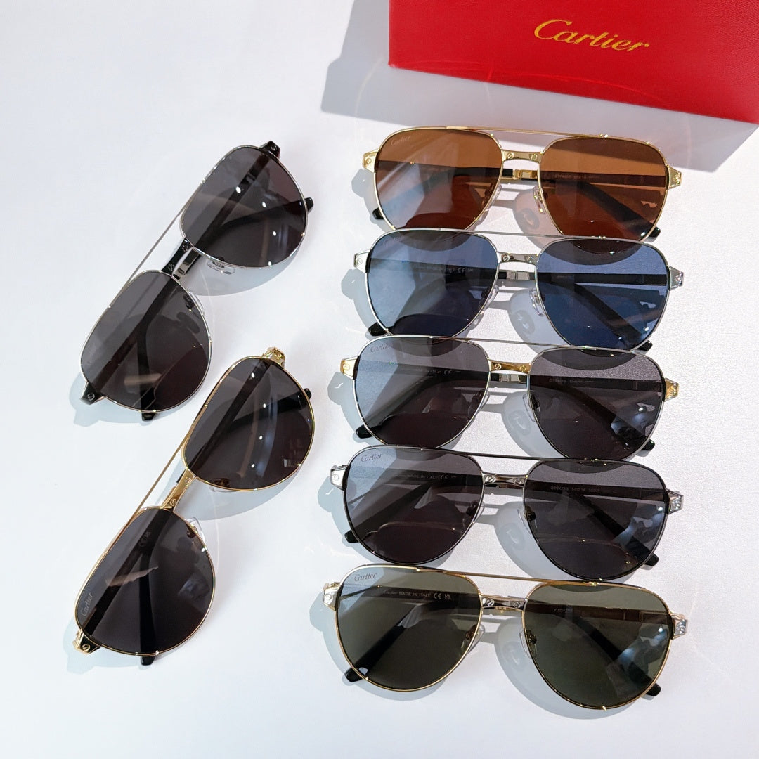 Assorted sunglasses with metal frames and tinted lenses, stacked