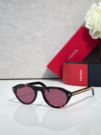 Prada sunglasses with tortoiseshell frames and pink tinted lenses