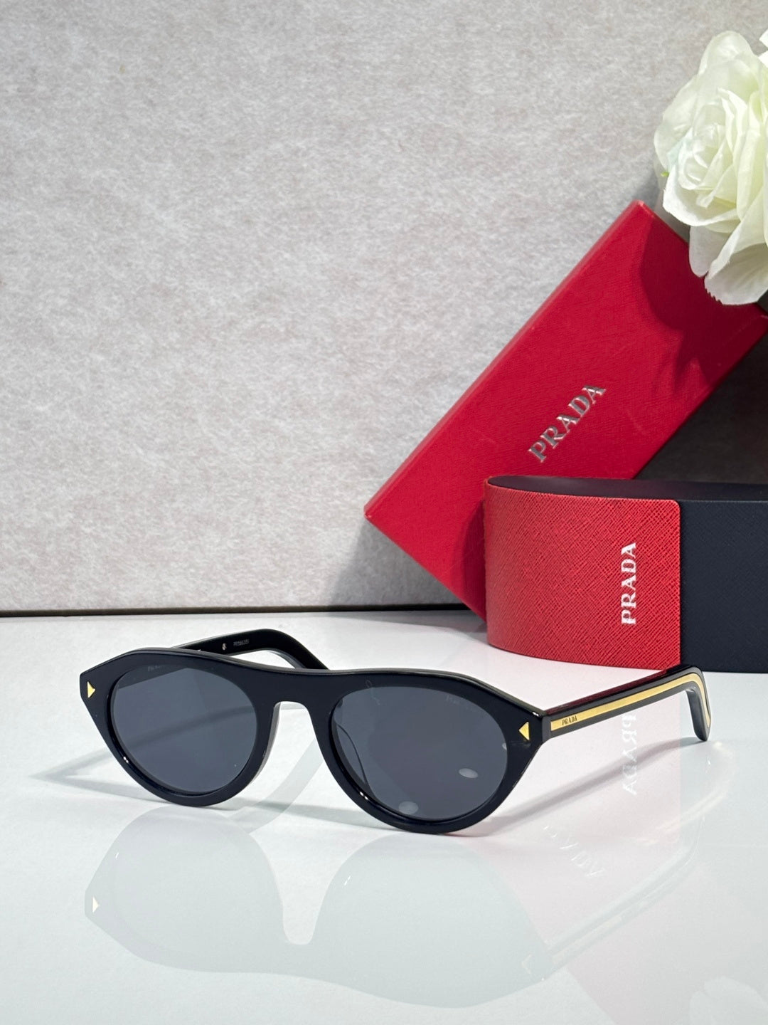 Prada sunglasses with black frames and dark gray lenses