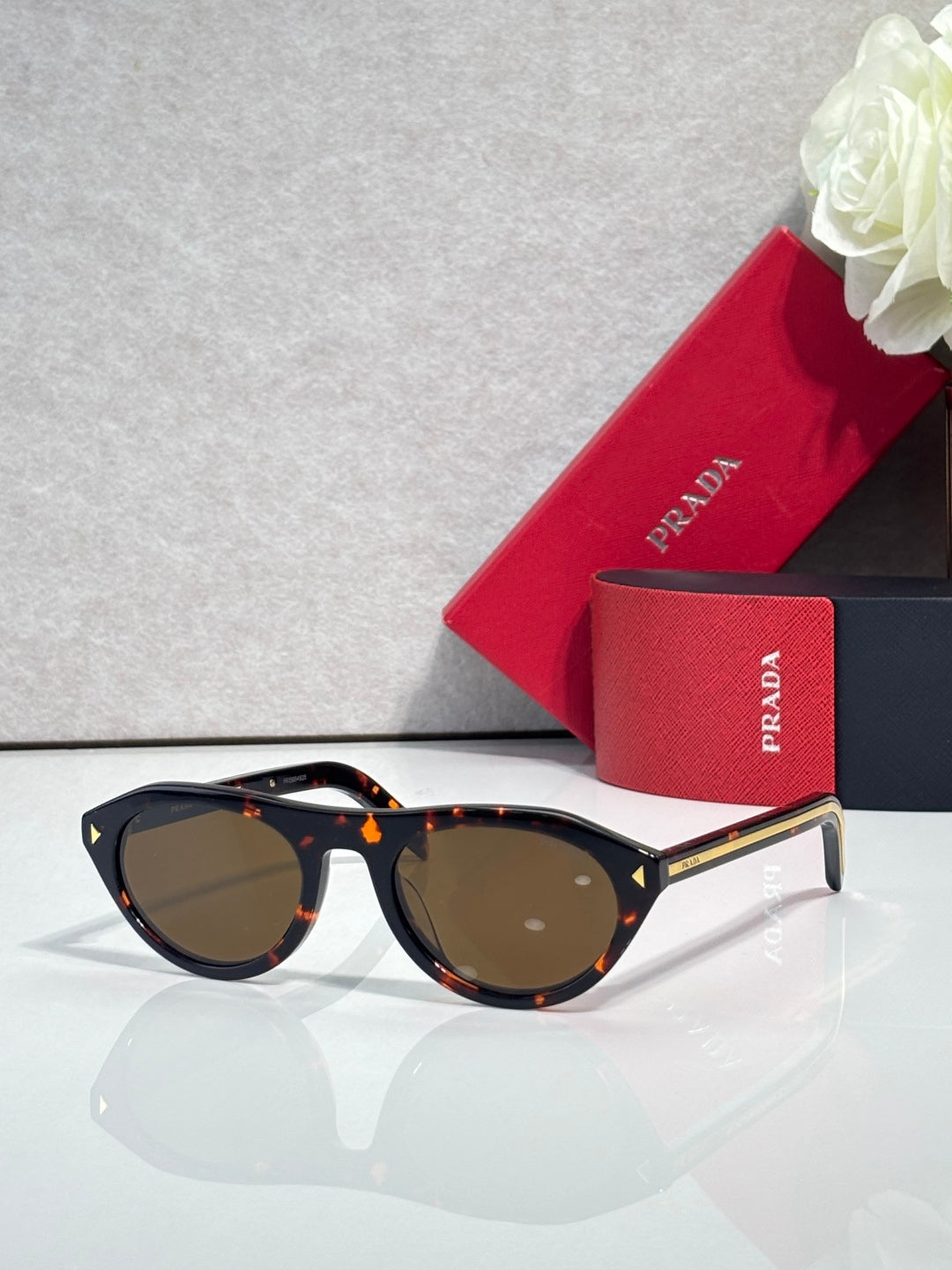 Prada sunglasses with tortoiseshell frames and dark brown lenses