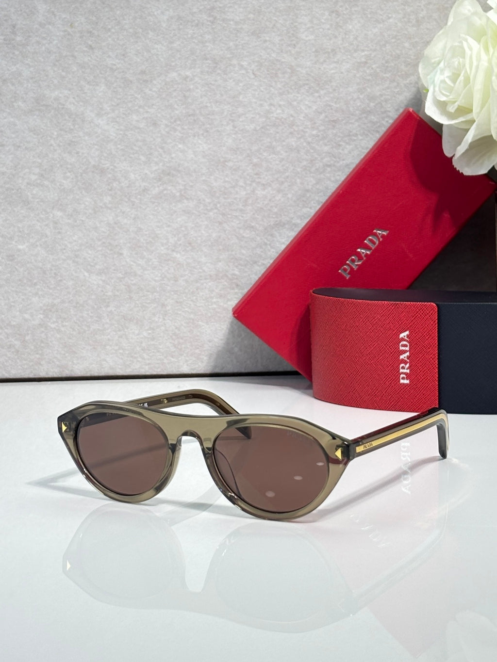 Prada sunglasses with tortoiseshell frames and brown lenses