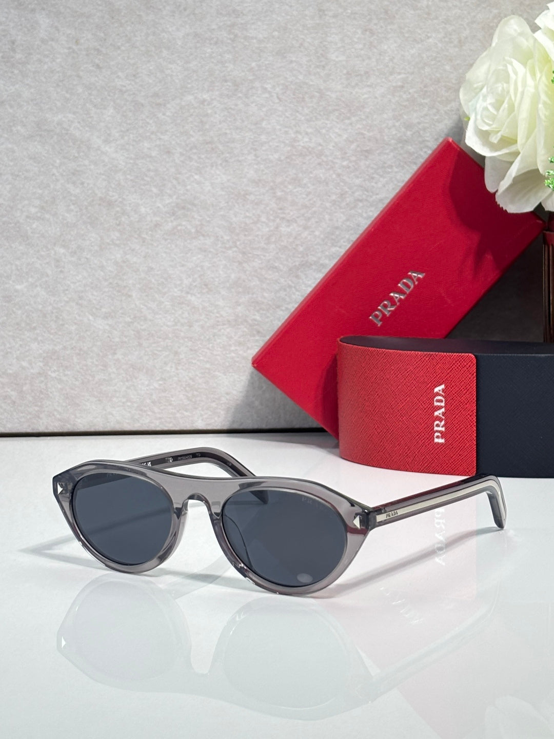 Prada sunglasses with dark frames and dark gray lenses