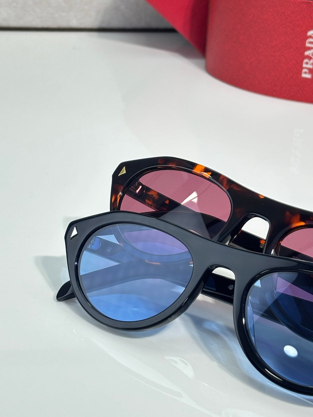 Dark sunglasses with blue-tinted lenses and tortoiseshell temples