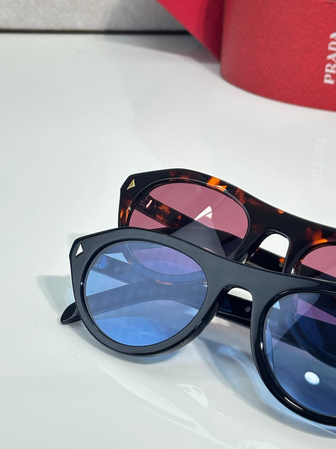 Dark sunglasses with blue-tinted lenses and tortoiseshell temples