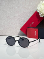 Prada round sunglasses with dark lenses and silver-tone frame, black temples