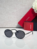 Prada round sunglasses with dark lenses and silver-tone frame, black temples