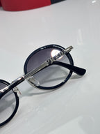 Prada round eyeglasses top view, dark lens and silver bridge with PRADA