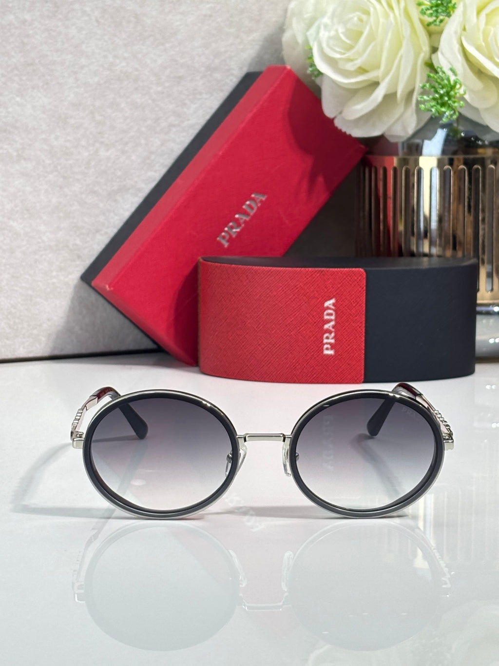 Prada round eyeglasses, dark lenses, black frame with silver hinges