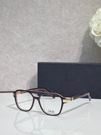 Rectangular eyeglasses with dark red frame, clear lenses, and Dior logo on bridge