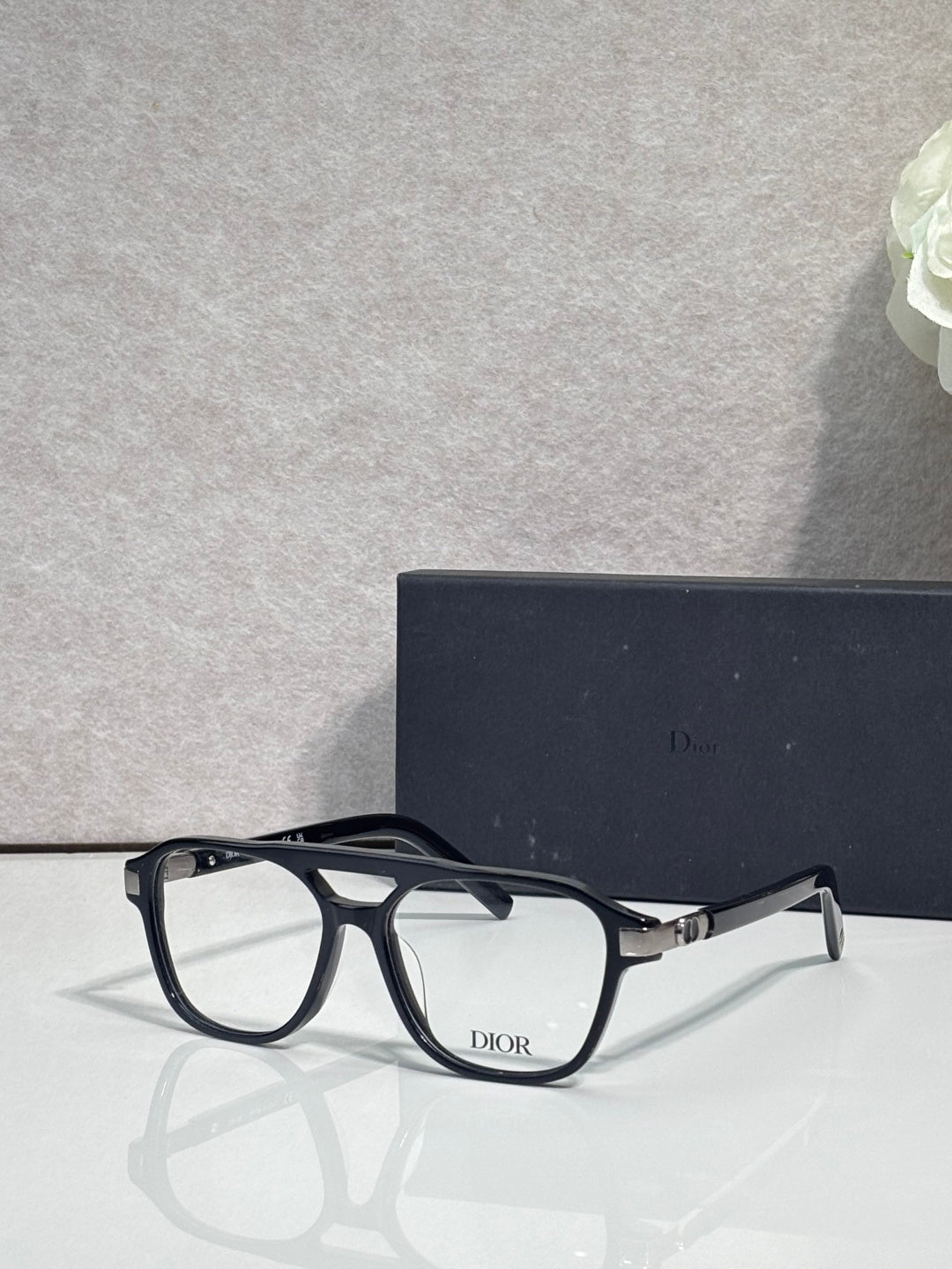 Rectangular eyeglasses with black frame, clear lenses, and Dior logo on temple