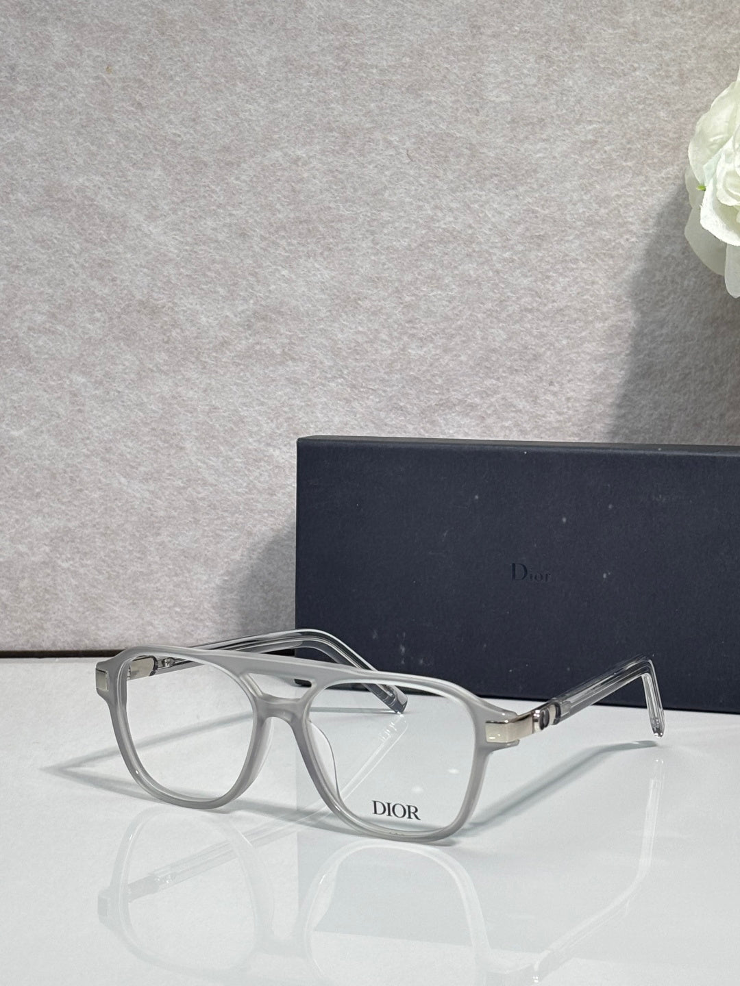 Rectangular eyeglasses with light gray frame and clear lenses, gold hinge detail