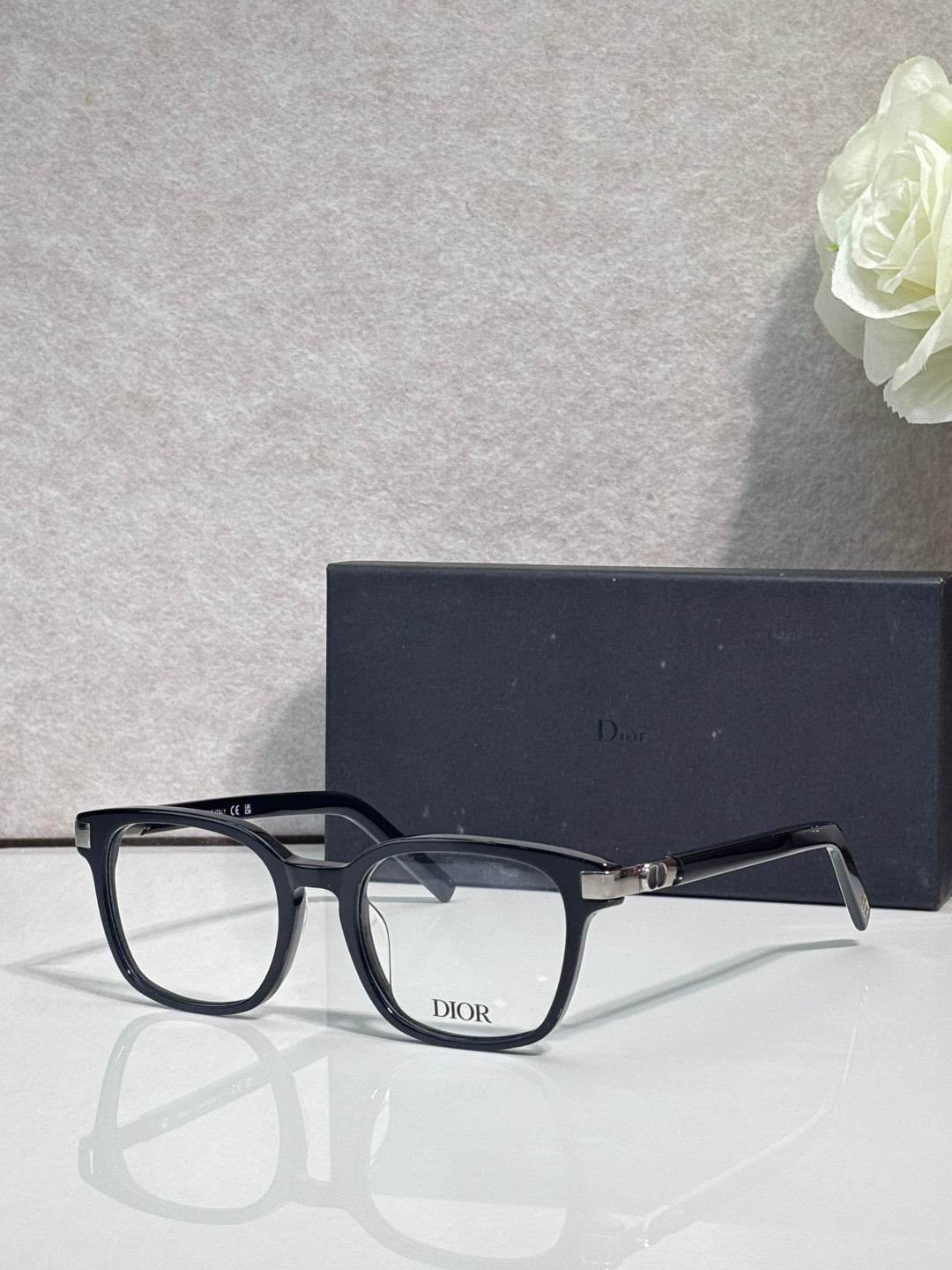 Dior eyeglasses with dark navy frames and gold-tone hinges with clear lenses