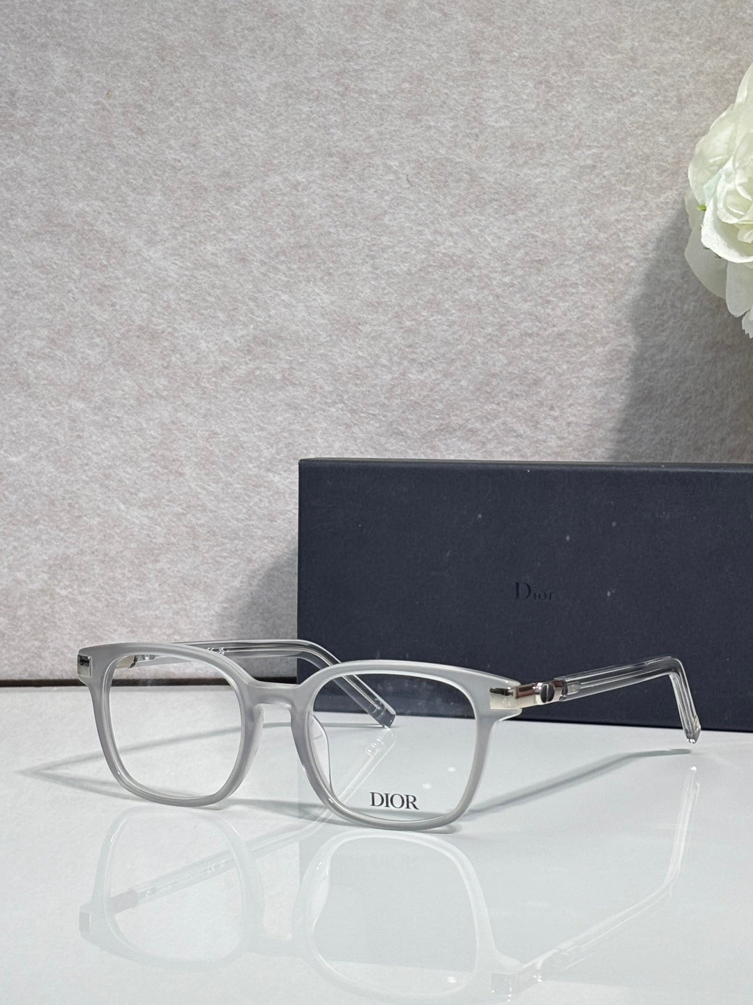Dior eyeglasses with silver-gray acetate frames and rectangular clear lenses